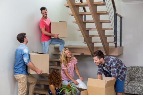 Professional moving van loading furniture in Poplar