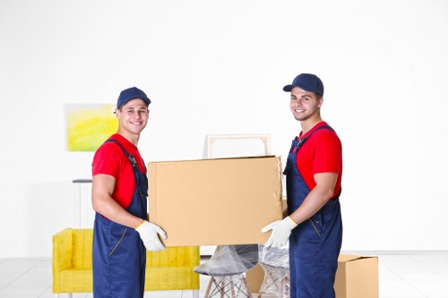 Professional movers preparing belongings for transport in Poplar