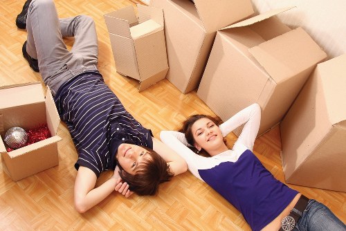 Careful packing for a Poplar flat move with labelled boxes and protective wrap